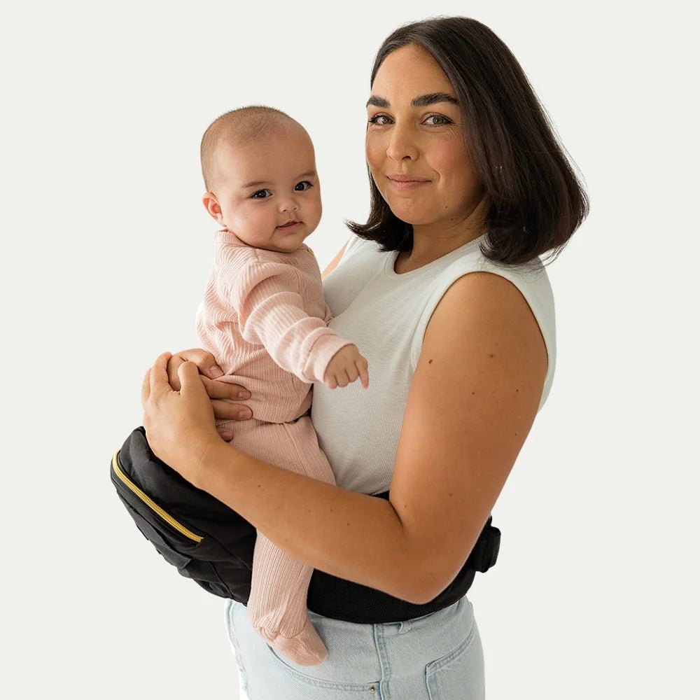 Tushbaby Hip Carrier for babies and toddlers, featuring adjustable straps and ergonomic design for comfortable carrying.