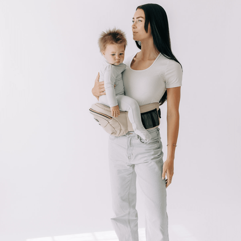 Tushbaby Hip Carrier for babies and toddlers, soft fabric with adjustable straps, designed for comfortable carrying.