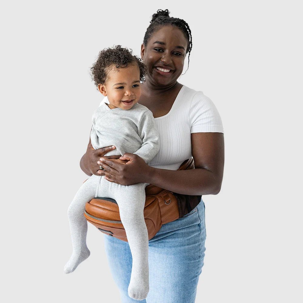 Tushbaby Hip Carrier for babies and toddlers, featuring padded straps and ergonomic design for comfortable carrying.