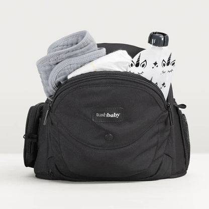 Tushbaby Hip Carrier for baby and toddler, showing the ergonomic design and adjustable straps in a neutral color.
