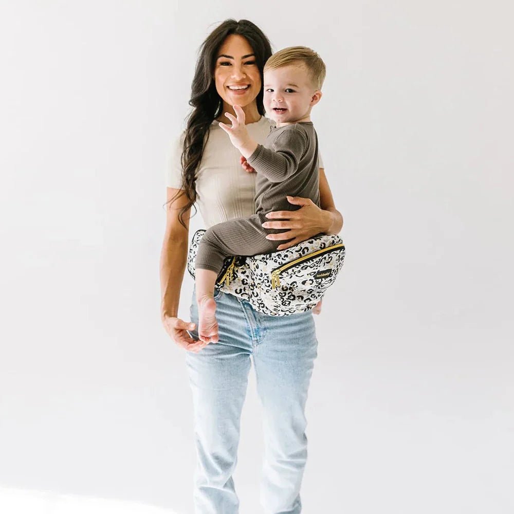 Tushbaby Hip Carrier for babies and toddlers, featuring ergonomic design and adjustable straps in soft fabric.