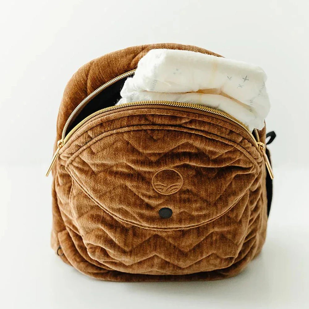 Baby being carried in the Tushbaby Hip Carrier, a comfortable and ergonomic baby and toddler carrier by Tushbaby.