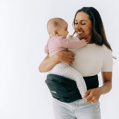 Tushbaby Hip Carrier for babies and toddlers, showing a comfortable ergonomic design with padded straps and supportive waist belt.