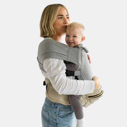 Tushbaby Hip Carrier for babies and toddlers, soft fabric with adjustable straps, supporting comfortable carrying for parents and children.