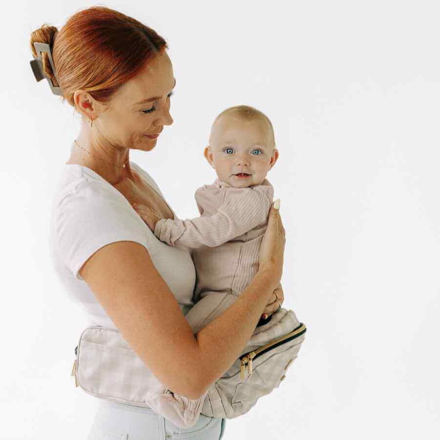 Tushbaby Hip Carrier for babies and toddlers, showing a comfortable, adjustable baby carrier worn around the hips with supportive straps.