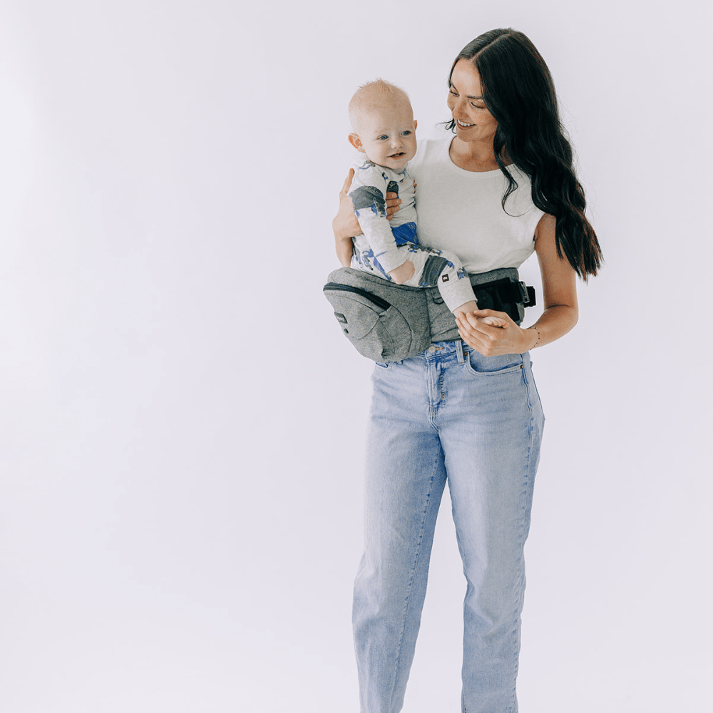 Tushbaby Hip Carrier for babies and toddlers, featuring adjustable straps and padded support for comfortable carrying.