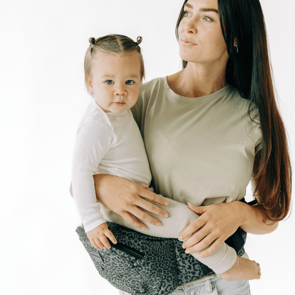 Tushbaby hip carrier for babies and toddlers, showing adjustable straps and ergonomic design for comfortable carrying.