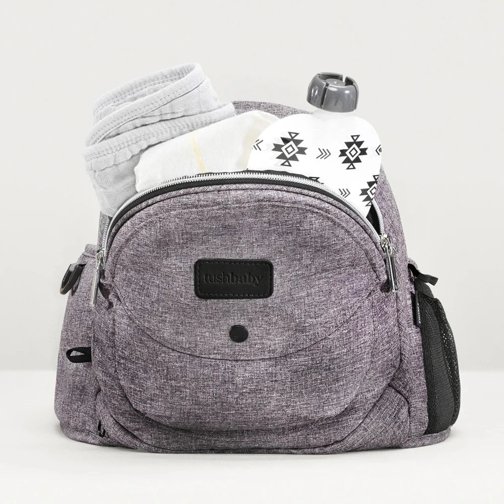 Baby wearing the Tushbaby Hip Carrier, a comfortable toddler carrier for parents, showing the supportive design and adjustable straps.