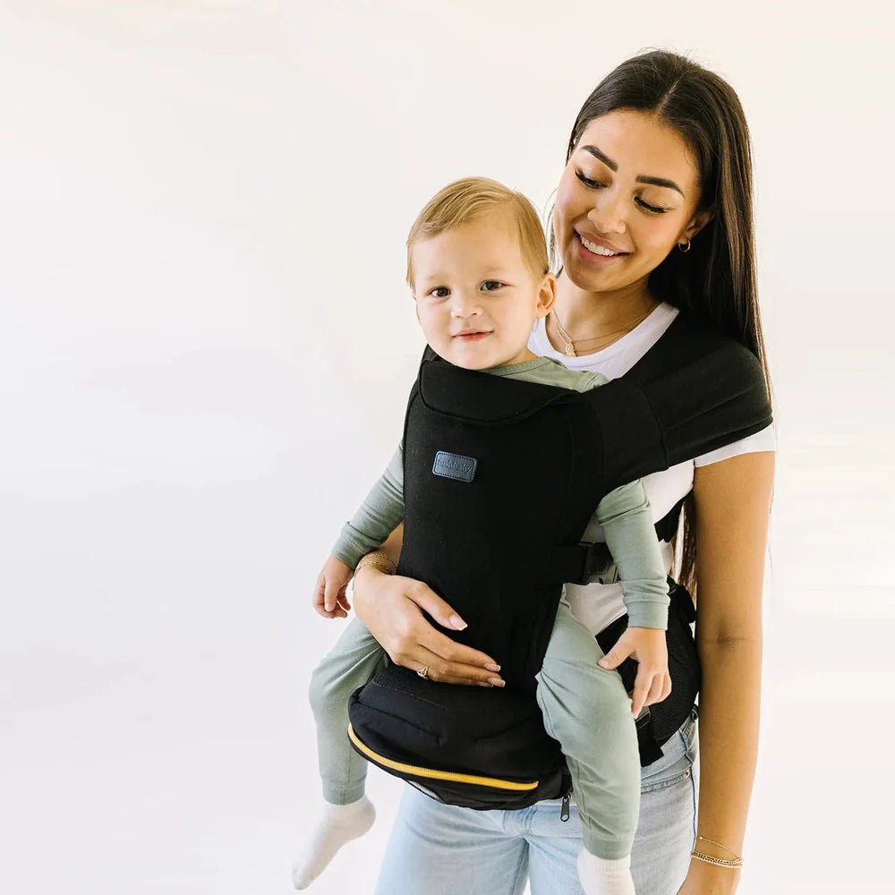 Tushbaby Hip Carrier for babies and toddlers, featuring adjustable straps and ergonomic design for comfortable carrying.