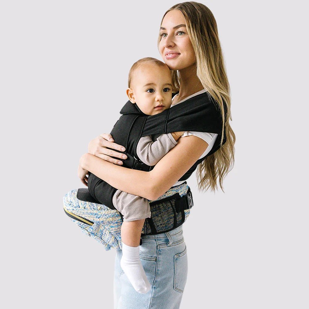 Tushbaby Hip Carrier for babies and toddlers, showing a comfortable, supportive design in a neutral color.