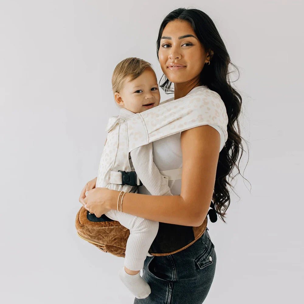 Tushbaby Hip Carrier for baby and toddler, featuring ergonomic design and adjustable straps for comfortable carrying.