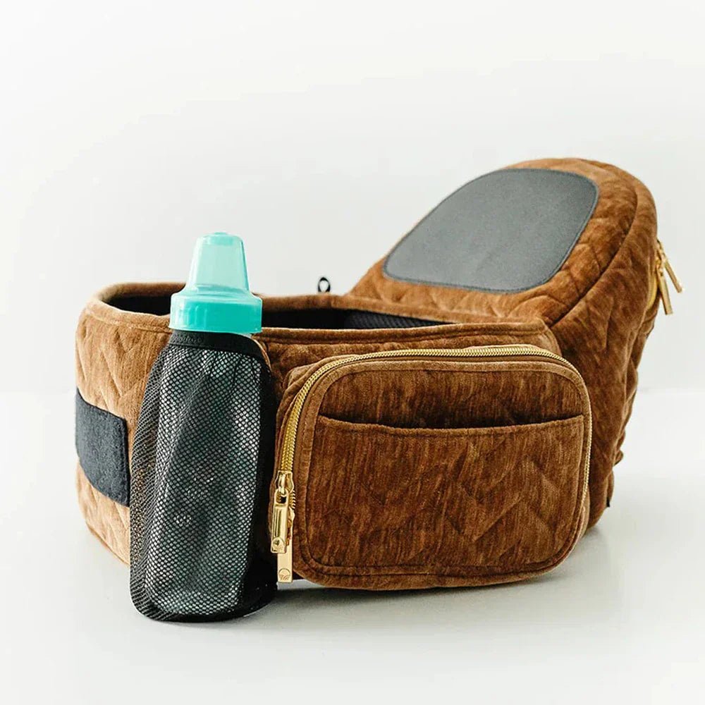 Tushbaby Hip Carrier for babies and toddlers, featuring adjustable straps and ergonomic design for comfortable carrying.