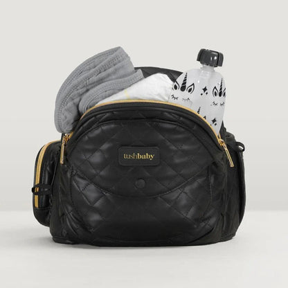 Tushbaby Hip Carrier for baby and toddler, showing ergonomic design and adjustable straps for comfortable carrying.