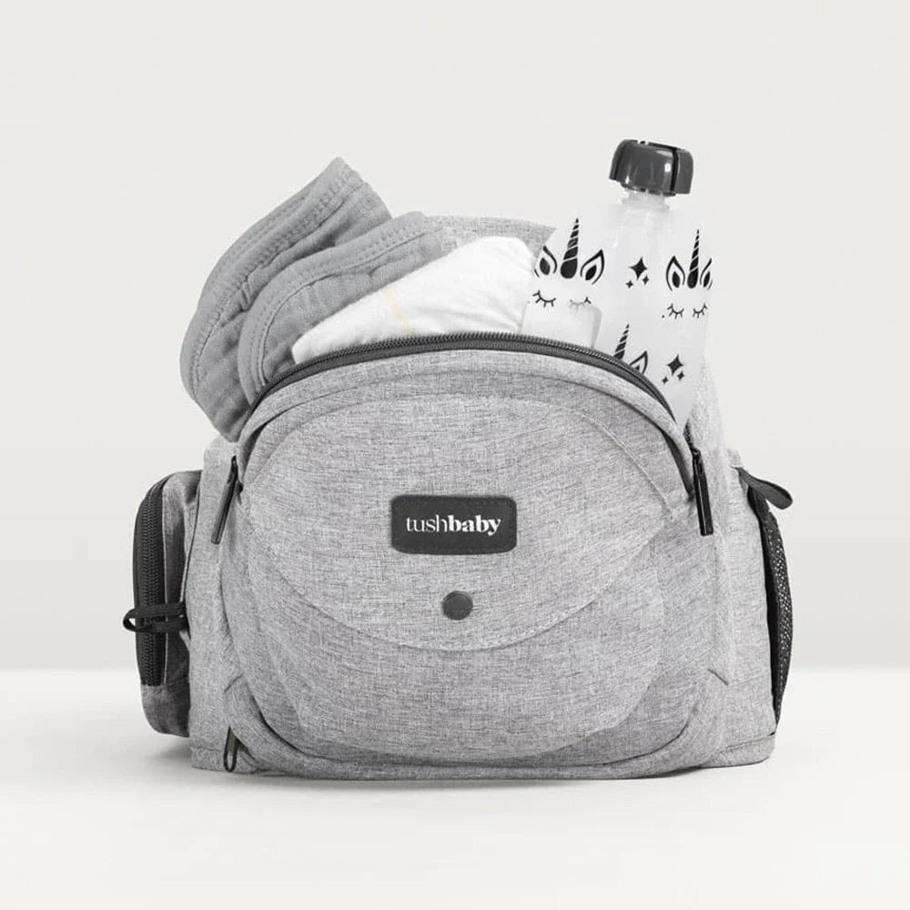Tushbaby Hip Carrier for baby and toddler, showing adjustable straps and comfortable fabric for secure carrying.