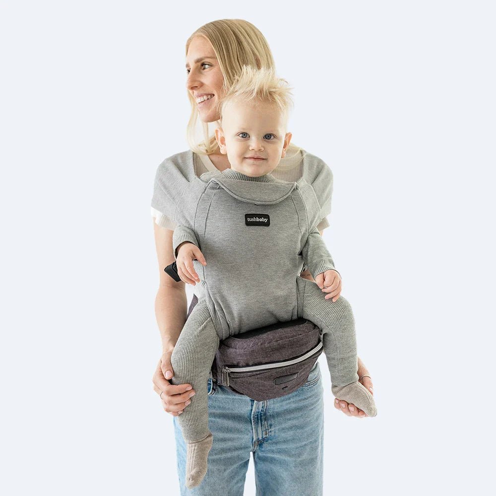 Tushbaby Hip Carrier for babies and toddlers in black, showing adjustable straps and ergonomic design for comfortable carrying.