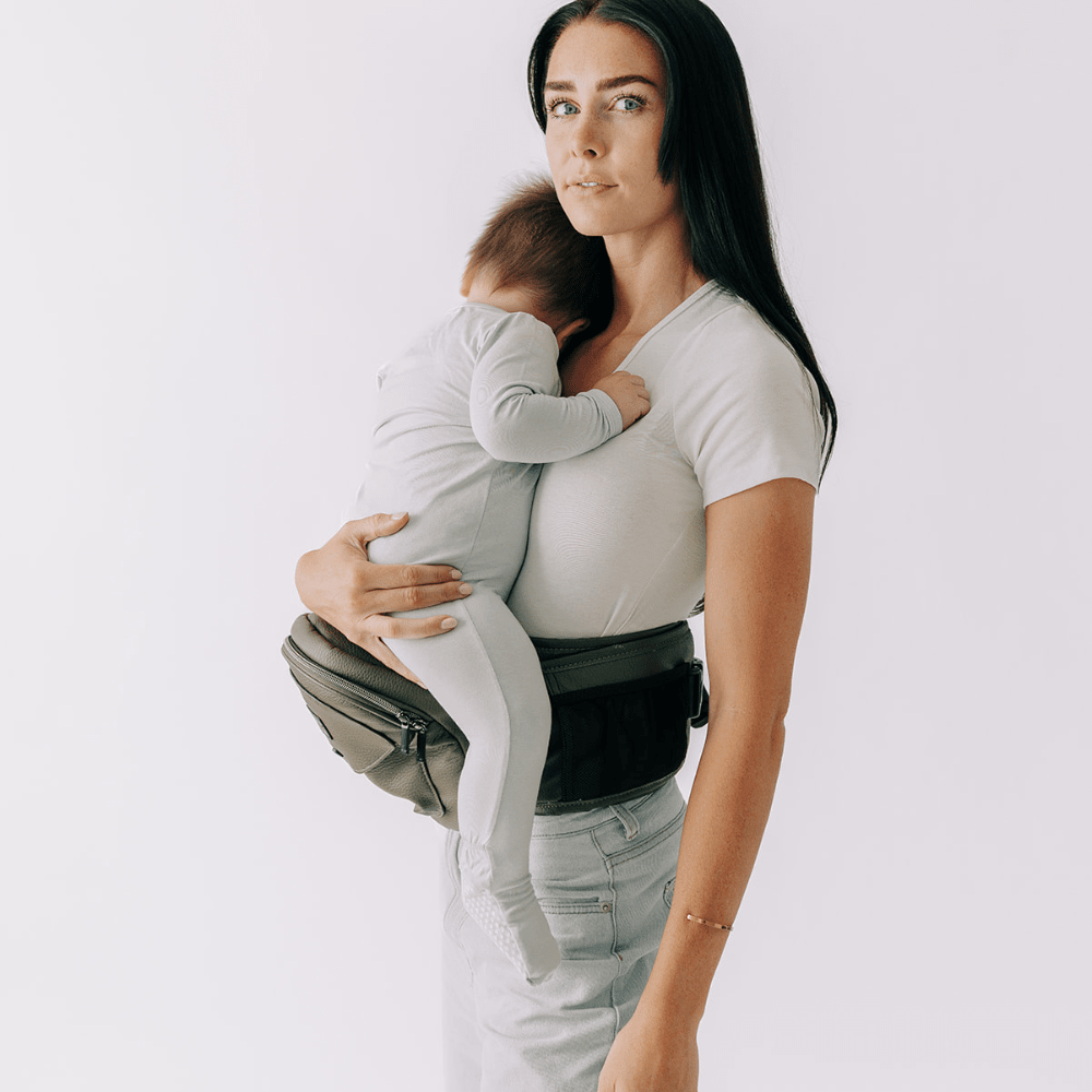 Tushbaby Hip Carrier for babies and toddlers, featuring ergonomic design and adjustable straps for comfortable carrying.