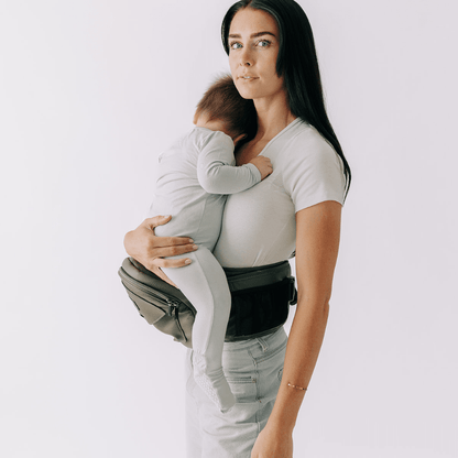 Tushbaby Hip Carrier for babies and toddlers, featuring ergonomic design and adjustable straps for comfortable carrying.