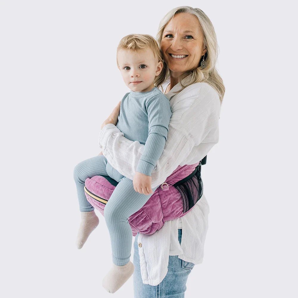 Baby and toddler hip carrier by Tushbaby, shown in a neutral color, designed to comfortably carry young children on the hips.