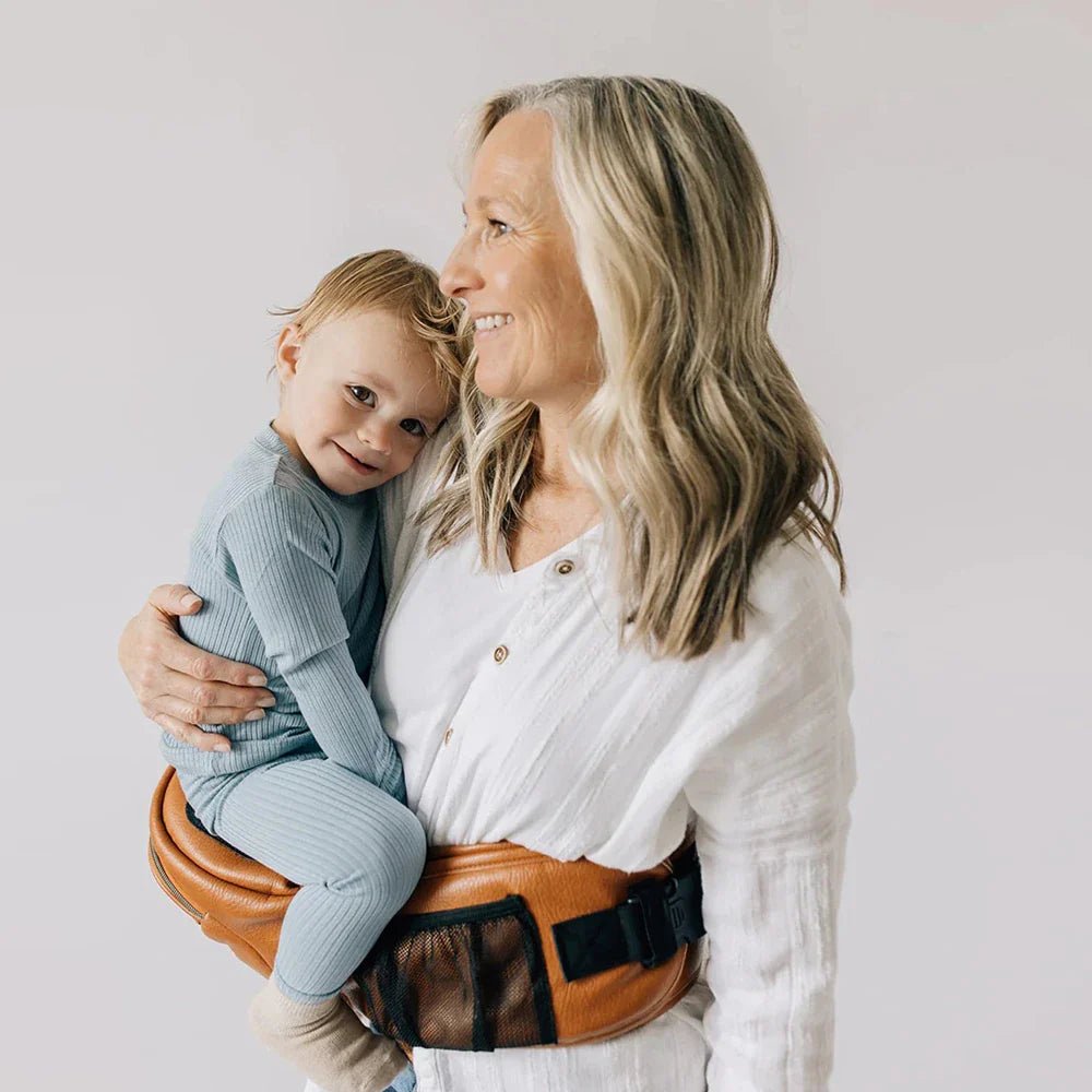 Tushbaby Hip Carrier for babies and toddlers, with ergonomic design and adjustable straps for comfortable carrying.