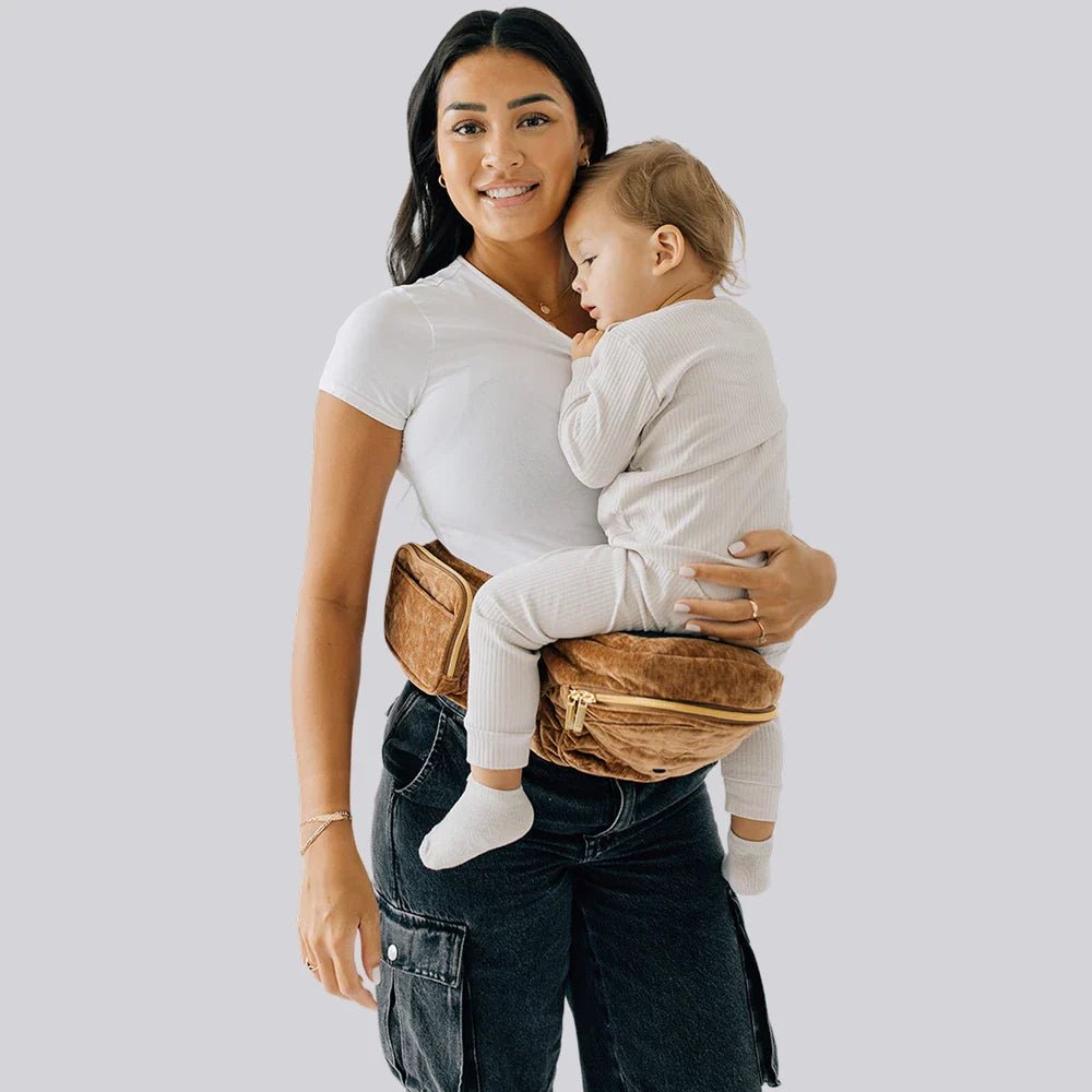 Tushbaby Hip Carrier for babies and toddlers, featuring adjustable straps and cushioned support for comfortable carrying.