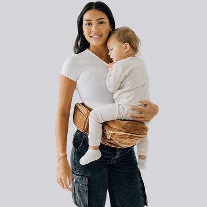 Tushbaby Hip Carrier for babies and toddlers, featuring adjustable straps and cushioned support for comfortable carrying.