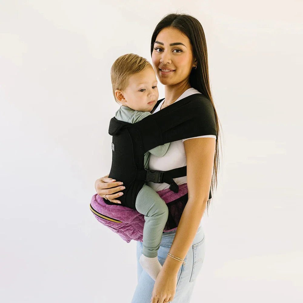 Tushbaby Hip Carrier for babies and toddlers, shown in use with adjustable straps and supportive design for parent comfort.