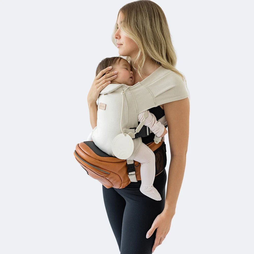 Tushbaby Hip Carrier for babies and toddlers, featuring adjustable straps and ergonomic design for comfortable carrying.