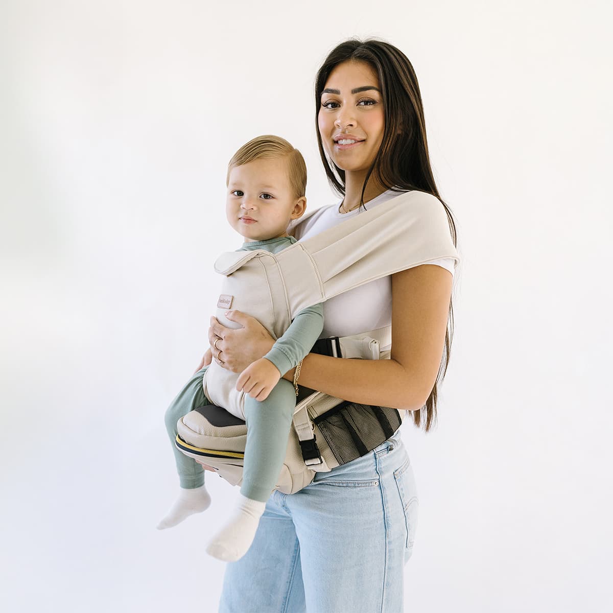 Tushbaby Hip Carrier for baby and toddler, showing adjustable straps and ergonomic design for comfortable carrying.