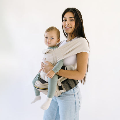 Tushbaby Hip Carrier for baby and toddler, showing adjustable straps and ergonomic design for comfortable carrying.