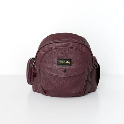 Tushbaby Hip Carrier for babies and toddlers, showcasing ergonomic design with adjustable straps and supportive seat.