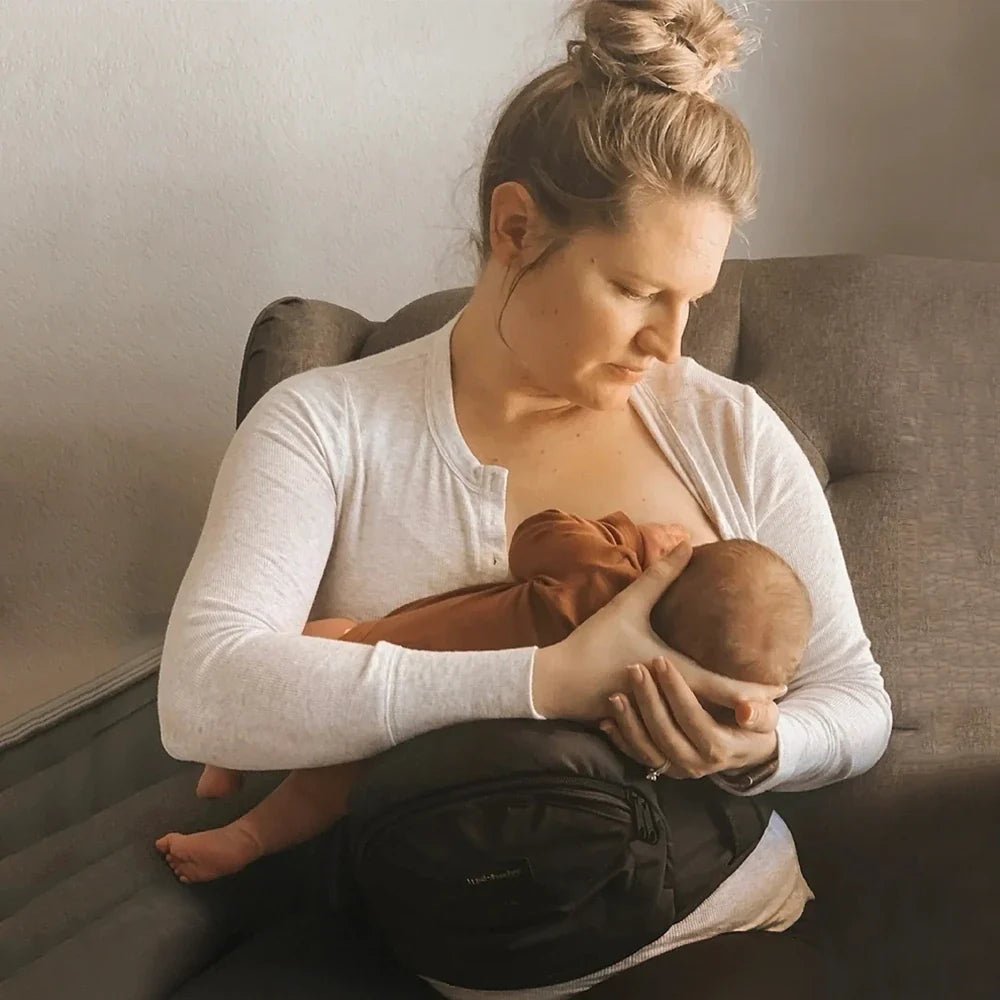 Baby wearing the Tushbaby Hip Carrier, a supportive ergonomic carrier for toddlers and babies from Tushbaby.
