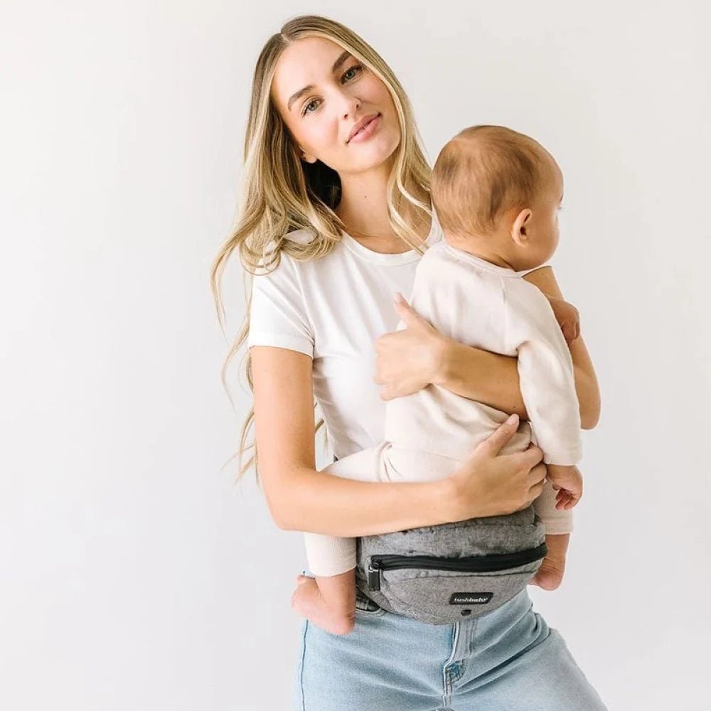 Tushbaby Hip Carrier for baby and toddler, black fabric with adjustable straps, designed for comfortable parent and baby support.