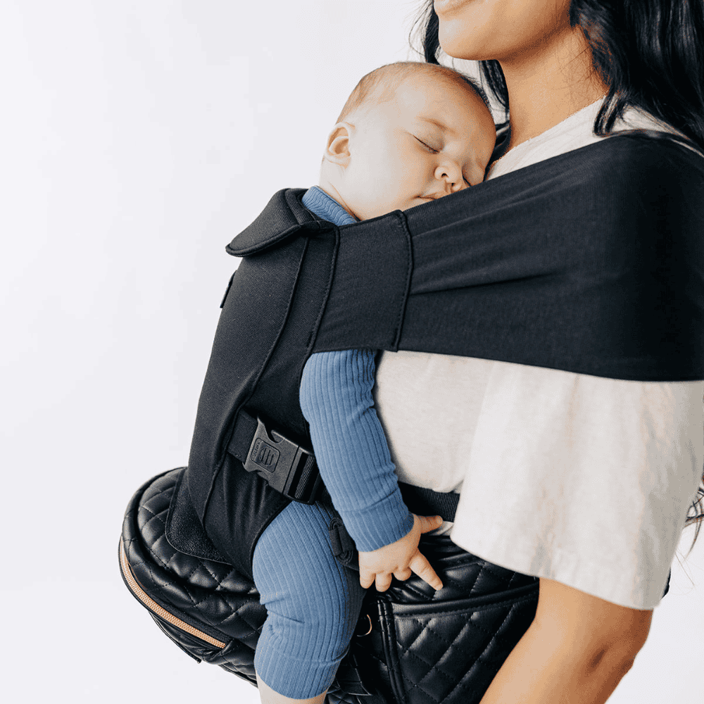 Tushbaby Hip Carrier for baby and toddler, featuring adjustable straps and ergonomic design for comfortable carrying.
