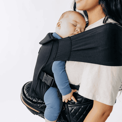 Tushbaby Hip Carrier for baby and toddler, featuring adjustable straps and ergonomic design for comfortable carrying.