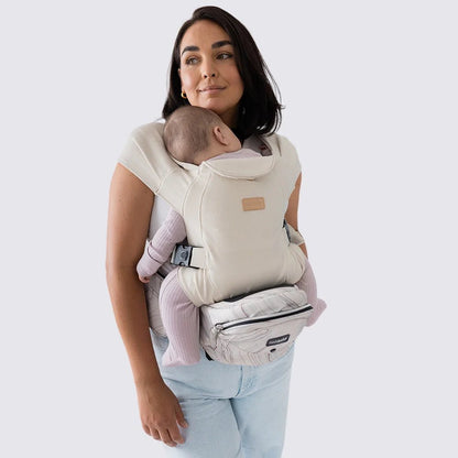 Tushbaby hip carrier for baby and toddler, showing adjustable straps and ergonomic design for comfortable carrying.