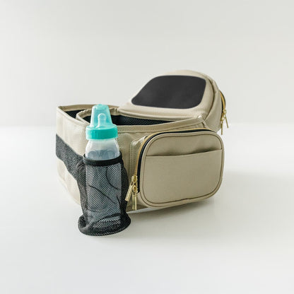 Tushbaby Hip Carrier for babies and toddlers, black fabric with padded waist belt and ergonomic design for comfortable carrying.
