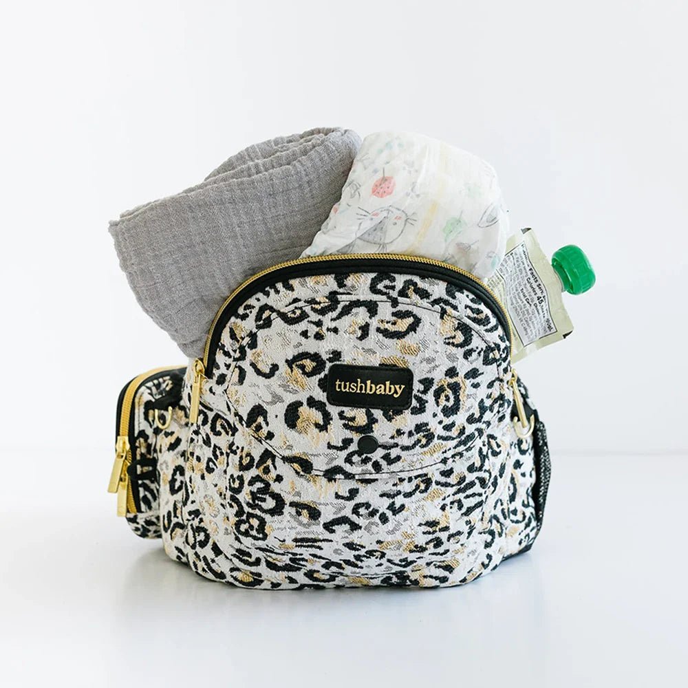 Tushbaby Hip Carrier for babies and toddlers, showing the ergonomic design and adjustable straps for comfortable wearing.