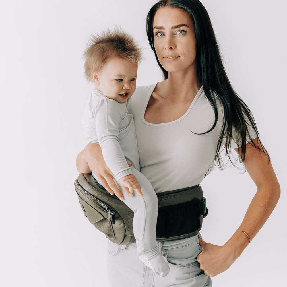 Baby and toddler hip carrier by Tushbaby, showing adjustable straps and ergonomic design for comfortable carrying.