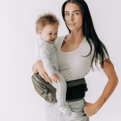 Baby and toddler hip carrier by Tushbaby, showing adjustable straps and ergonomic design for comfortable carrying.