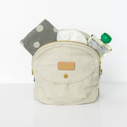 Baby sitting in the Tushbaby Hip Carrier, a comfortable and supportive baby carrier for toddlers by Tushbaby.