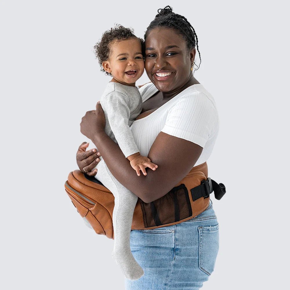 Tushbaby Hip Carrier for baby and toddler, featuring adjustable straps and supportive design for comfortable carrying.