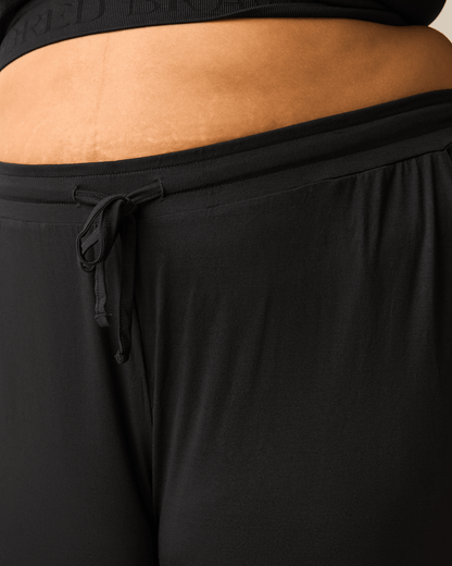 Black ultralight sleep and lounge joggers from Kindred Bravely, featuring a relaxed fit and comfortable elastic waistband.