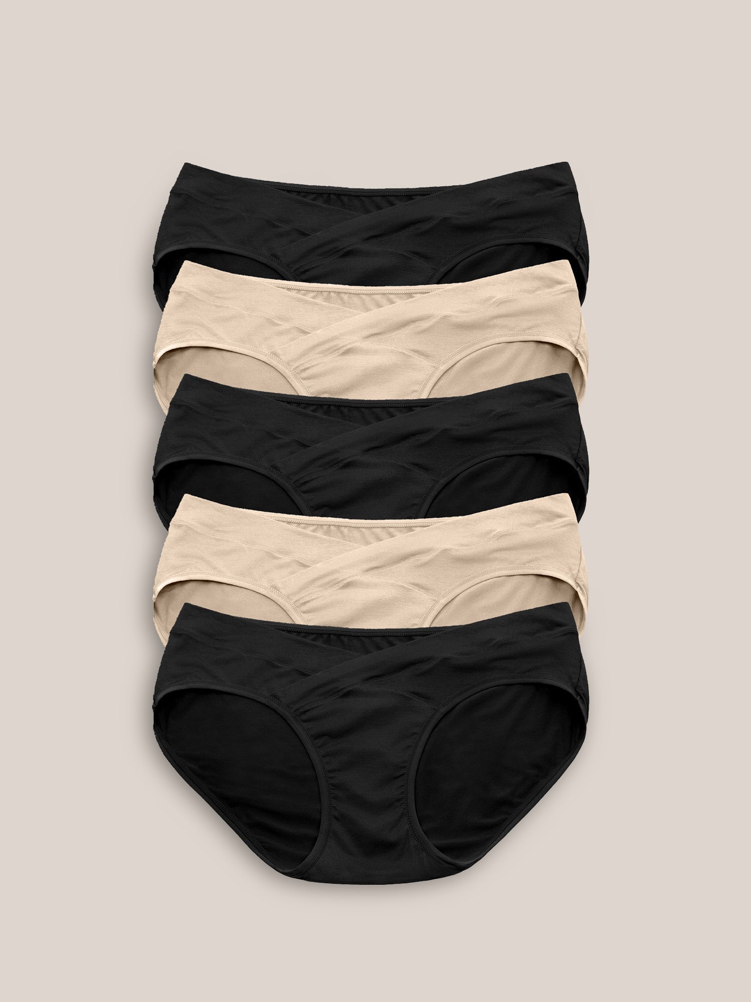 Set of neutral-colored under-the-bump bikini underwear by Kindred Bravely, low-rise style, soft and comfortable for maternity wear.